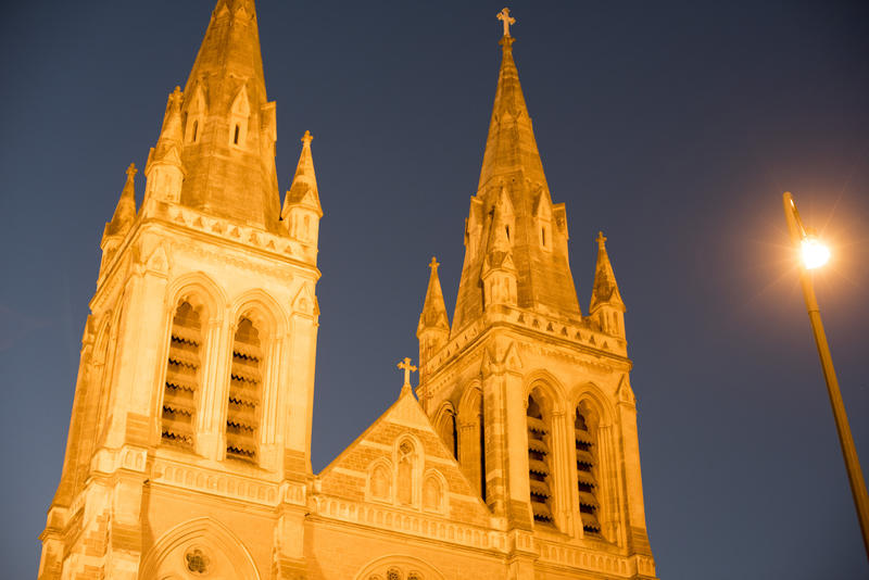 Illuminated spires of St Peters Cathedral, Adelaide, Australia at night in a close up low angle view